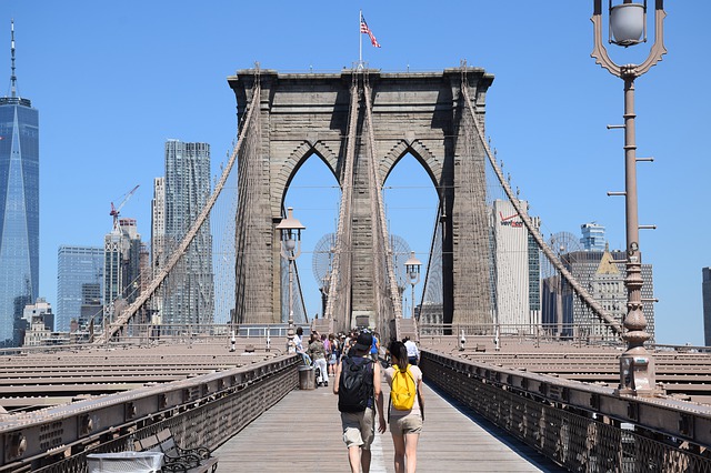 Tourists walking across the Brooklyn Bridge