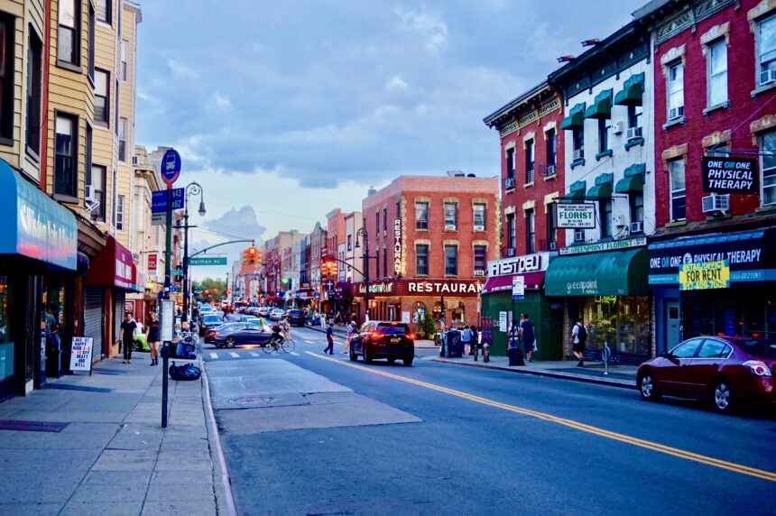 Greenpoint, Brooklyn, NY: city street view at dusk, with traffic lights, buildings, cars, street lamps. Resources for Brooklyn, NY