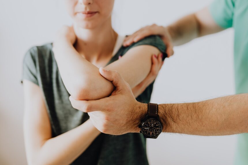 pexels-karola-g-4506075 Doctor examining a female patient's elbow and arm for pain